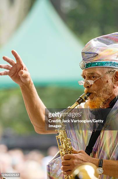 American Jazz musician and bandleader Marshall Allen plays on alto saxophone as he leads the Sun Ra Arkestra during a performance at Central Park...
