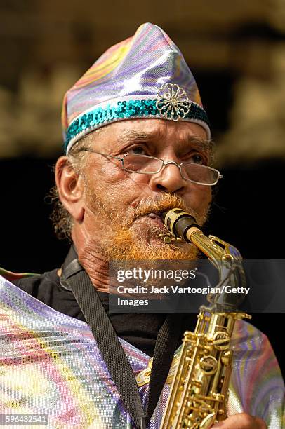 American Jazz musician and bandleader Marshall Allen plays on alto saxophone as he leads the Sun Ra Arkestra during a performance at Central Park...