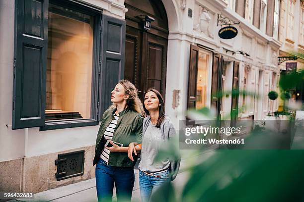 austria, vienna, two female friends exploring the old town - austria city stock pictures, royalty-free photos & images