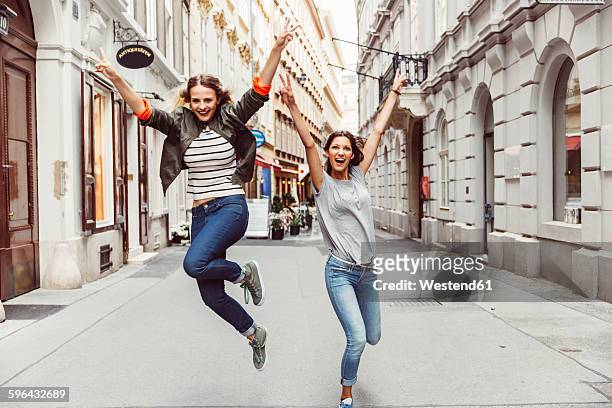 austria, vienna, two excited female friends in the old town - joy stock-fotos und bilder