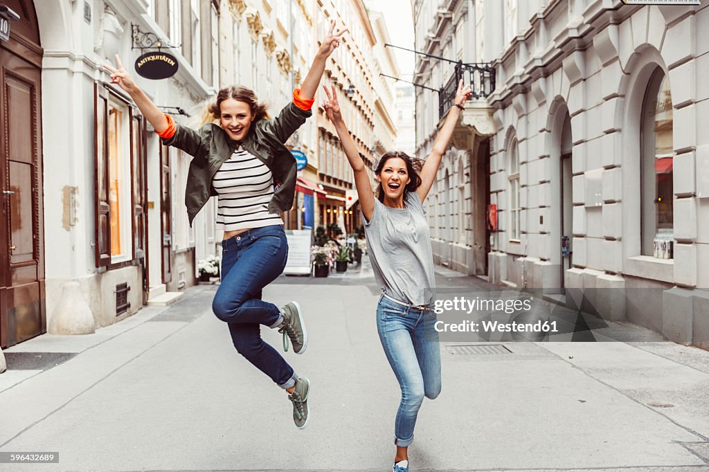 Austria, Vienna, two excited female friends in the old town