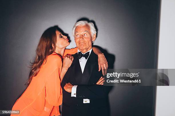 young woman embracing elegant senior man - senior young woman stockfoto's en -beelden