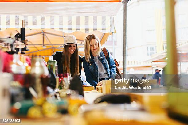 two young women at a stall on flea market - barcelona shopping stock pictures, royalty-free photos & images