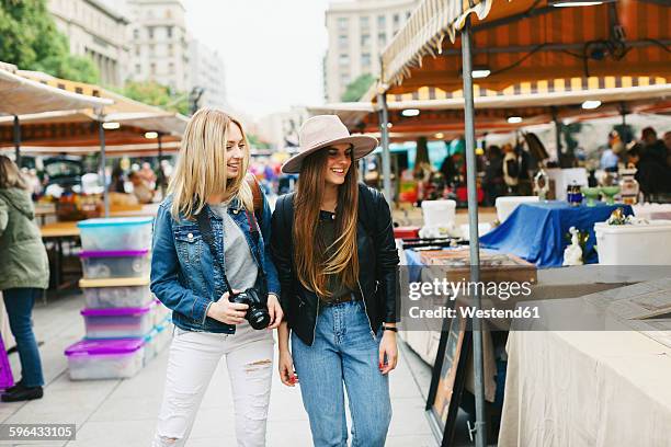 spain, barcelona, two young women on flea market - flohmarkt stock-fotos und bilder