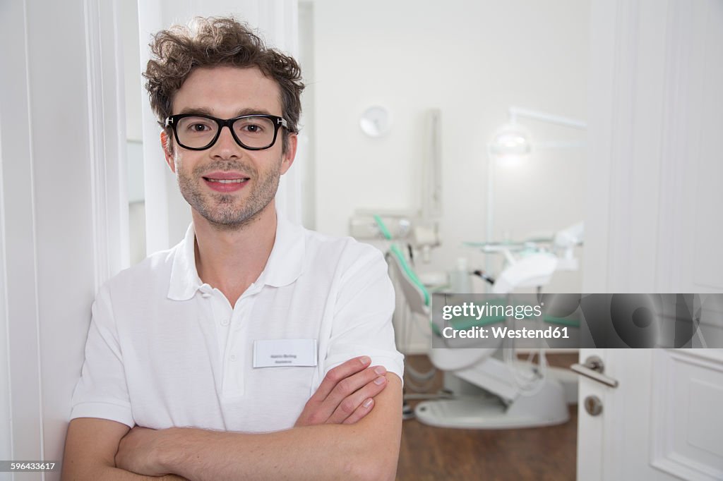 Portrait of smiling dentist at surgery
