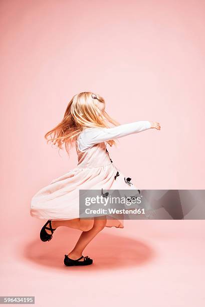 little girl dancing in front of pink background - pink dress stock pictures, royalty-free photos & images
