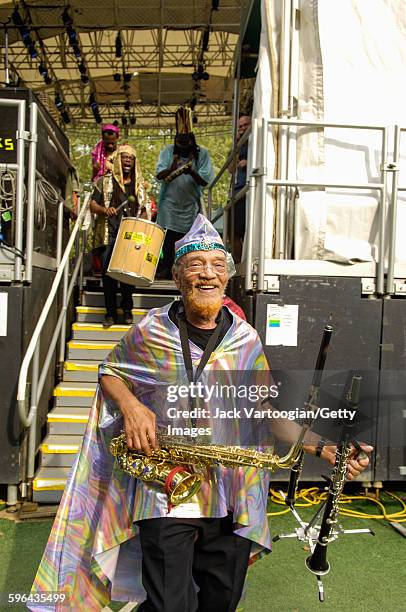 American Jazz musician and bandleader Marshall Allen plays on alto saxophone as he leads the Sun Ra Arkestra off the stage during a performance at...