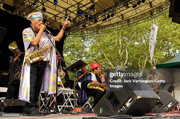 American Jazz musician and bandleader Marshall Allen plays on alto saxophone as he leads the Sun Ra Arkestra during a performance at Central Park...