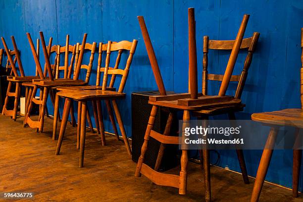 germany, munich, beer fest, stacked wooden chairs in beer tent at the old beer fest - beer hall - fotografias e filmes do acervo