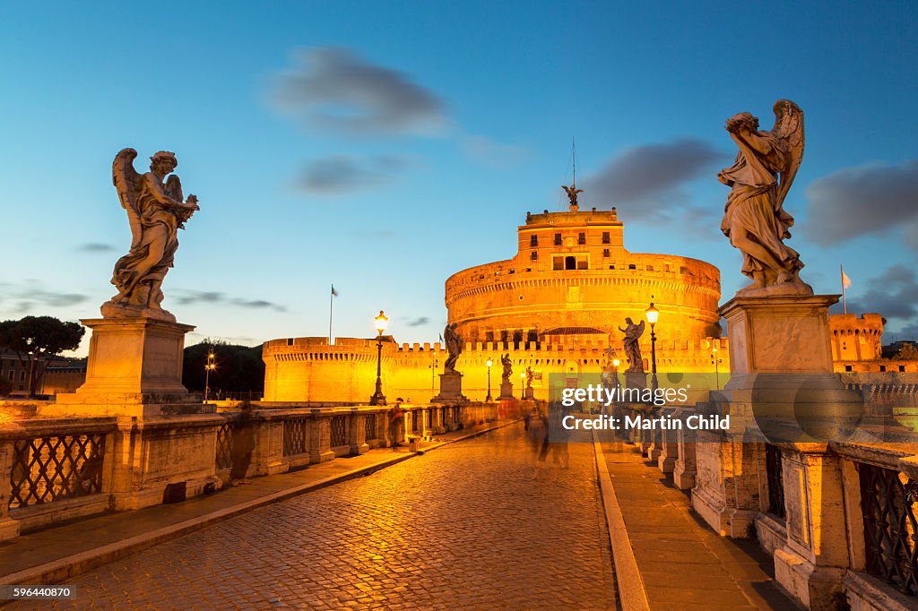 Angel Statues On Ponte Sant Angelo Bridge With Castel Sant Angelo At angel-statues-on-ponte-sant-angelo-bridge-with-castel-sant-angelo-at