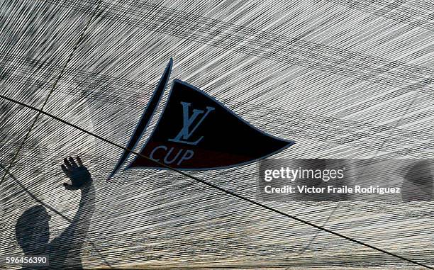 June 2007, Valencia, Spain --- 32nd America's Cup challenger Areva Challenge's bowman Sean Couvreux is silhouetted through the jib as he works on the...