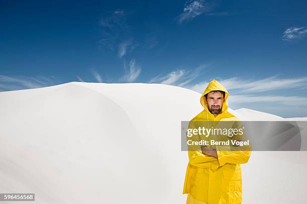 man wearing raincoat in sun - vintage rainwear stock-fotos und bilder