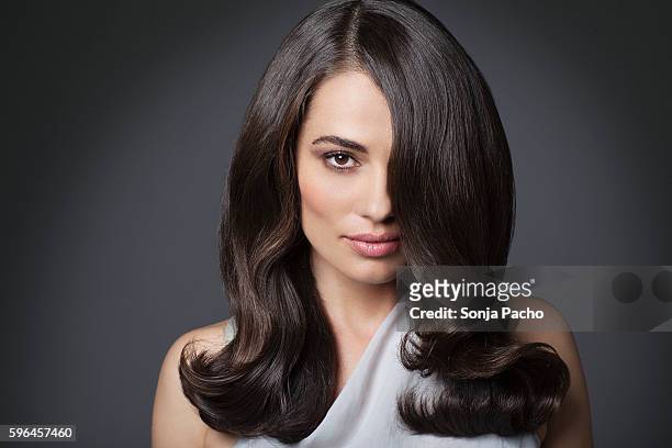portrait of beautiful woman with long brunette hair - stile di capelli foto e immagini stock