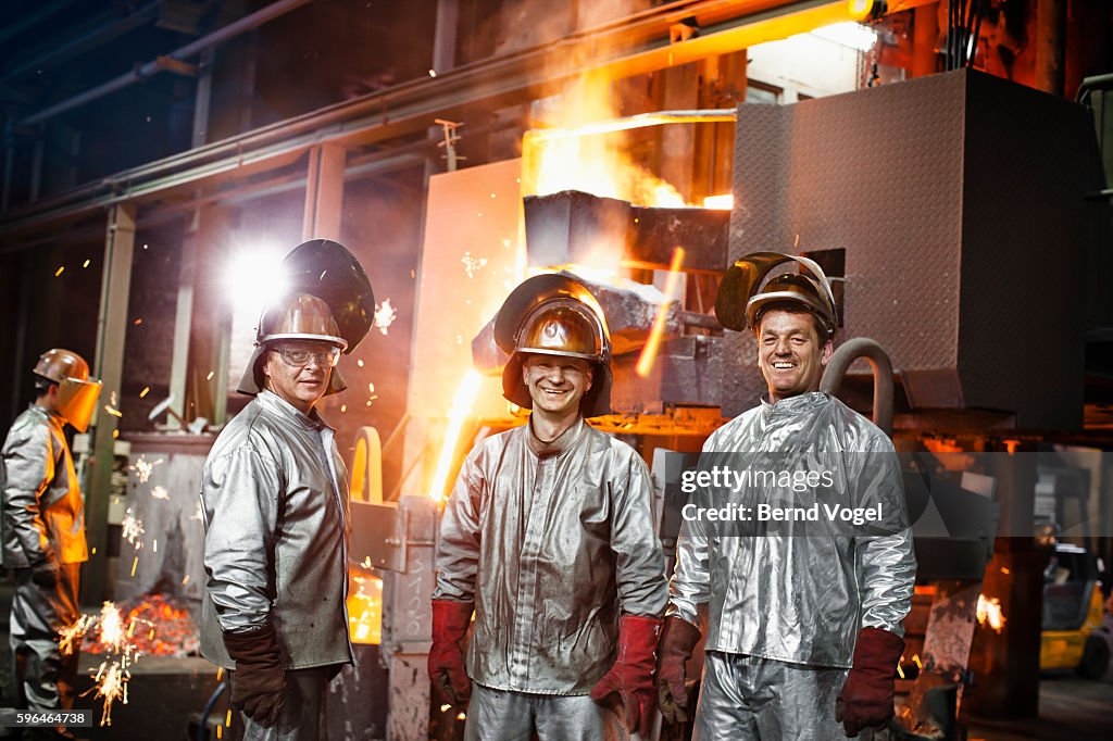 Steel workers working with liquid metal