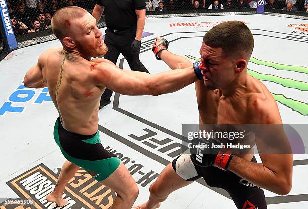 Conor McGregor of Ireland punches Nate Diaz in their welterweight bout during the UFC 202 event at T-Mobile Arena on August 20, 2016 in Las Vegas,...