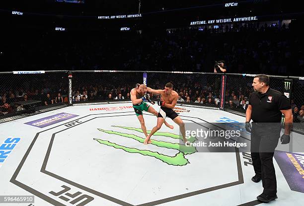 Conor McGregor of Ireland kicks Nate Diaz in their welterweight bout during the UFC 202 event at T-Mobile Arena on August 20, 2016 in Las Vegas,...