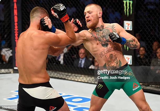 Conor McGregor of Ireland punches Nate Diaz in their welterweight bout during the UFC 202 event at T-Mobile Arena on August 20, 2016 in Las Vegas,...