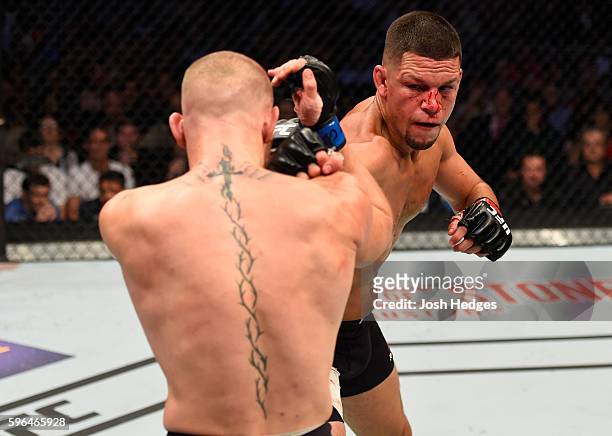 Nate Diaz punches Conor McGregor of Ireland in their welterweight bout during the UFC 202 event at T-Mobile Arena on August 20, 2016 in Las Vegas,...