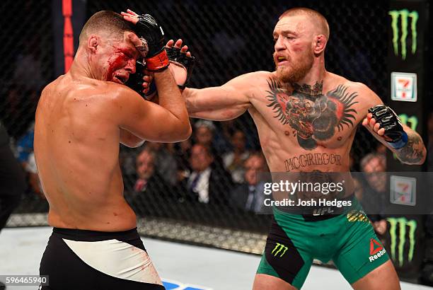 Conor McGregor of Ireland punches Nate Diaz in their welterweight bout during the UFC 202 event at T-Mobile Arena on August 20, 2016 in Las Vegas,...