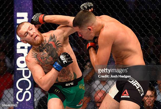 Conor McGregor of Ireland exchanges punches with Nate Diaz in their welterweight bout during the UFC 202 event at T-Mobile Arena on August 20, 2016...