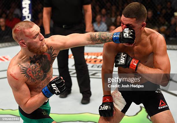 Conor McGregor of Ireland punches Nate Diaz in their welterweight bout during the UFC 202 event at T-Mobile Arena on August 20, 2016 in Las Vegas,...