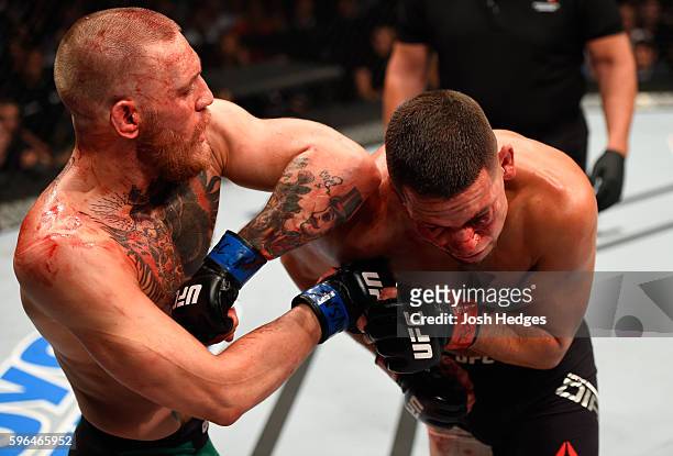 Conor McGregor of Ireland elbows Nate Diaz in their welterweight bout during the UFC 202 event at T-Mobile Arena on August 20, 2016 in Las Vegas,...