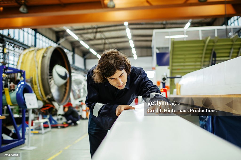 Male aircraft mechanic inside an aircraft hangar