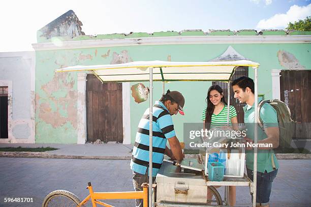 couple buy an ice-cream from street vendor. - eco tourism stock pictures, royalty-free photos & images