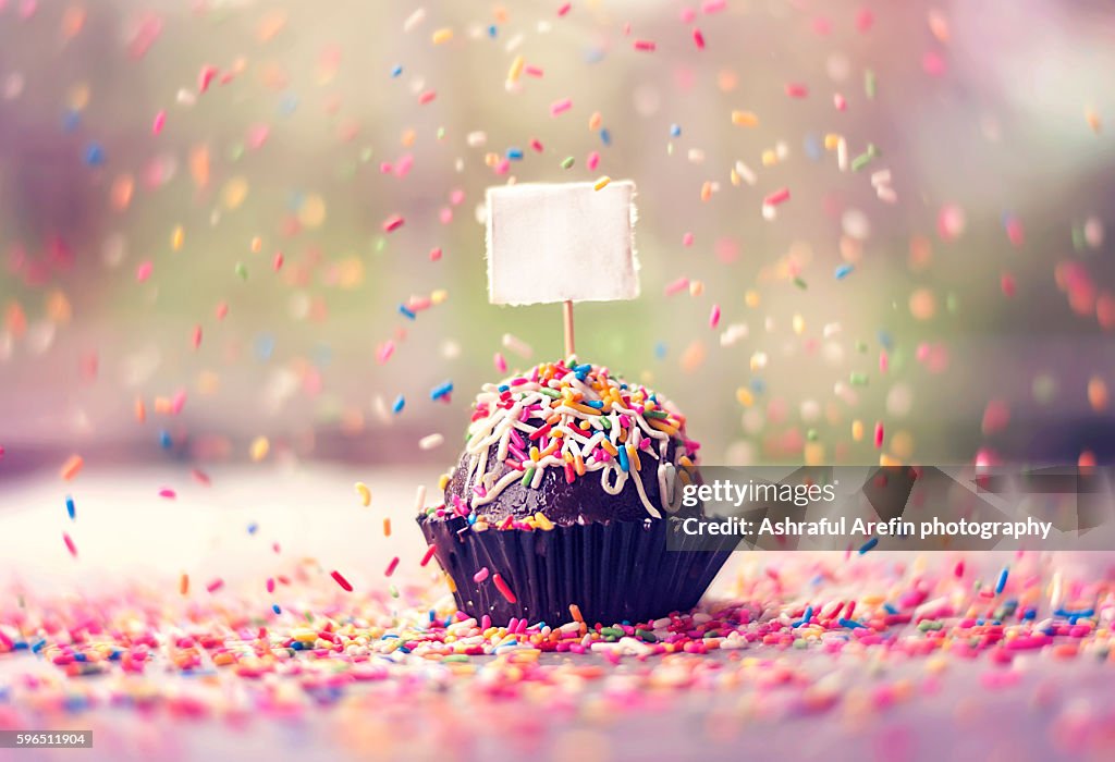 Chocolate truffle cake with falling sprinklers