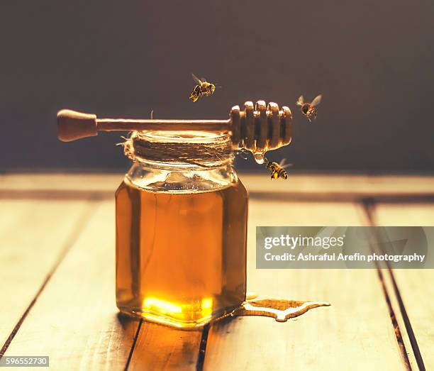 jar of honey with honey dripper and bees - honey jar stock pictures, royalty-free photos & images