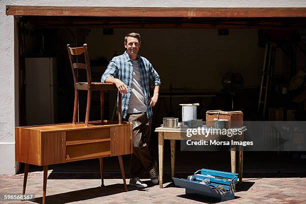 happy man with furniture outside house - standing table outside stock pictures, royalty-free photos & images