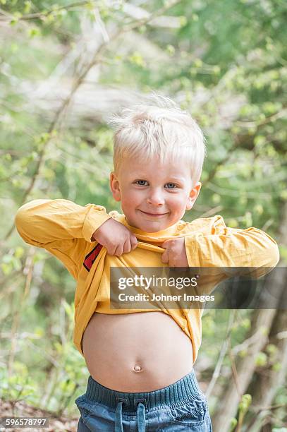 smiling boy showing belly - kids belly stock pictures, royalty-free photos & images