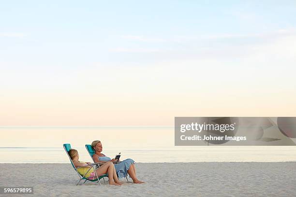 mother with daughter relaxing on beach - faro sweden bildbanksfoton och bilder