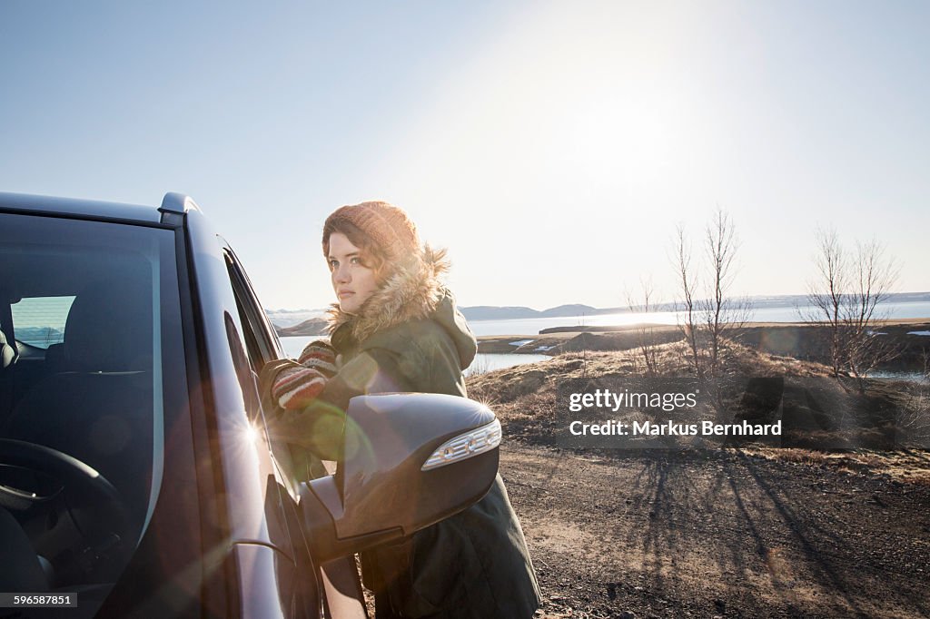 Woman leaning at her car