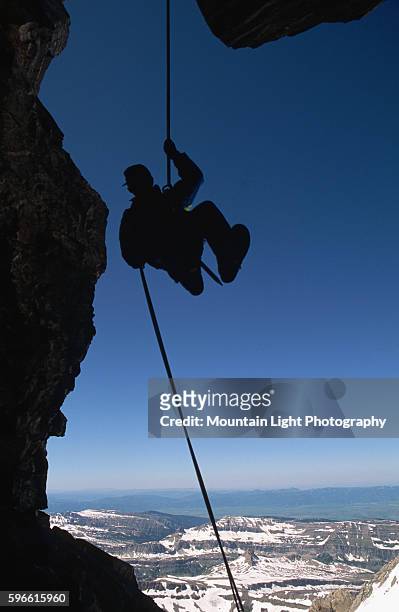 Climber in Silhouette Rappelling off Grand Teton