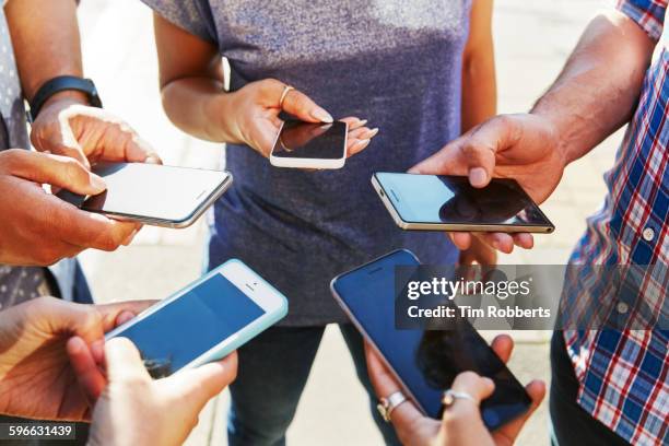 5 friends with smartphones, close up. - sns ストックフォトと画像