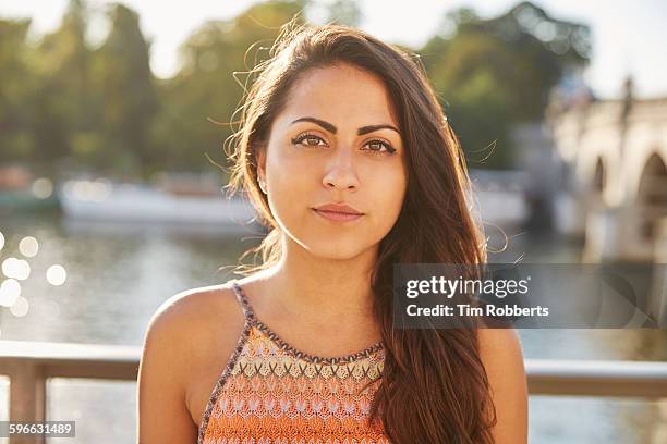 portrait of young woman in front of river. - asian woman long hair stock pictures, royalty-free photos & images