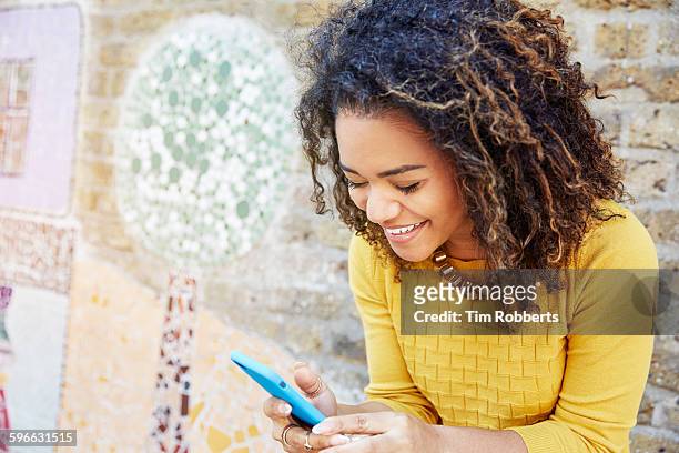 woman smiling with smart phone - happy smile with phone stock pictures, royalty-free photos & images