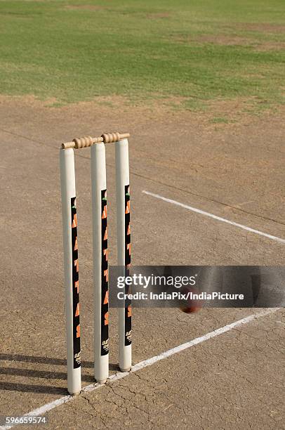 cricket ball approaching stumps - cricket field stock pictures, royalty-free photos & images