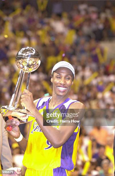 Lisa Leslie of the Los Angeles Sparks holds the 2001 Championship trophy after defeating the Charlotte Sting in game two of the WNBA Finals at...