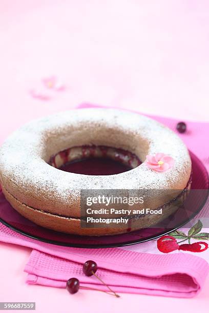 simple cake filled with cherry jam - sponge cake stock pictures, royalty-free photos & images