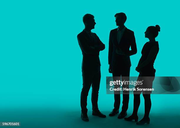 3 young business people in siloette - three people silhouette stock pictures, royalty-free photos & images