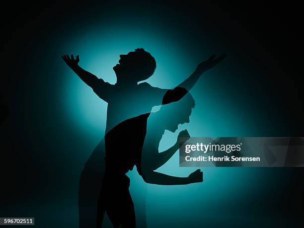 siloette double exposure of young man - fist silhouette stock pictures, royalty-free photos & images