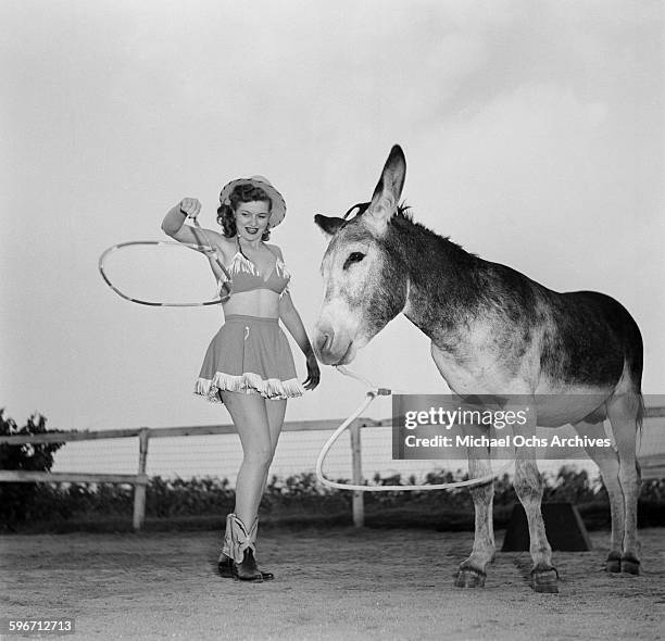 Betty Ames and her donkey Jackson perform a rope trick in Los Angeles,California.