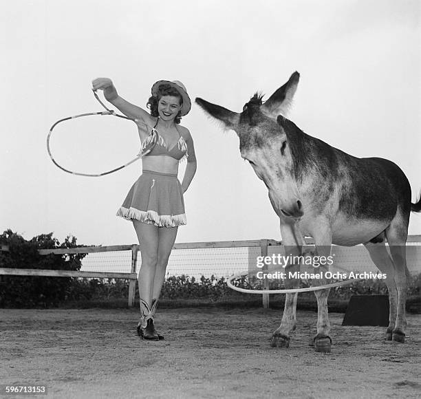 Betty Ames and her donkey Jackson perform a rope trick in Los Angeles,California.