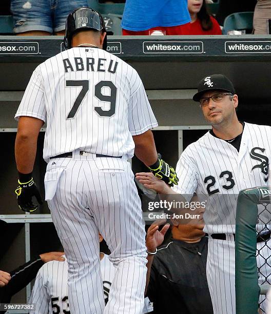 Manager Robin Ventura of the Chicago White Sox congratulates Jose Abreu on his home run against the Seattle Mariners during the first inning as he...