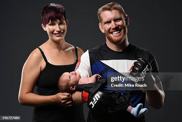 Sam Alvey of the United States poses for a post fight portrait with his family backstage during the UFC Fight Night event at Rogers Arena on August...