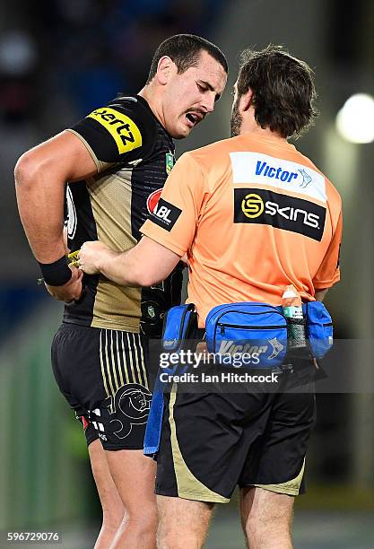 Reagan Campbell-Gillard of the Panthers is seen by a trainer after being injured during the round 25 NRL match between the Gold Coast Titans and the...