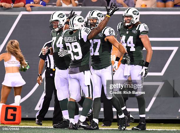 Eric Decker of the New York Jets celebrates his touchdown with Nick Mangold, Jalin Marshall and Zach Sudfeld of the New York Jets against the New...