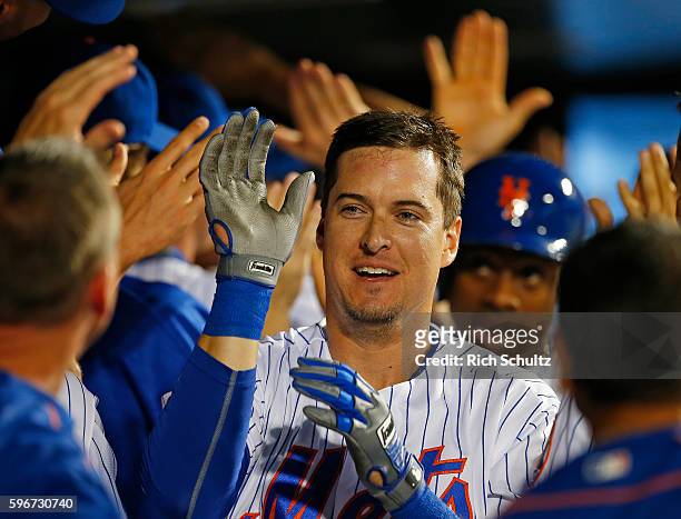 Kelly Johnson of the New York Mets is congratulated after he hit a grand slam home run against the Philadelphia Phillies during the seventh inning of...